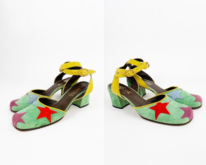 May include: A pair of green suede heeled shoes with a yellow ankle strap and multi-colored star accents. The shoes are labeled "La Rose" on the insole.