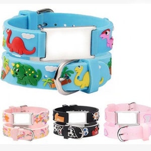 May include: Two-piece adjustable silicone bracelet with a blank tag. The bracelet is available in blue, pink, black, and light blue with various cartoon designs.
