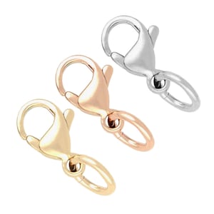 May include: Three lobster claw clasps in different finishes: silver, gold, and rose gold. These clasps are commonly used for jewelry making.