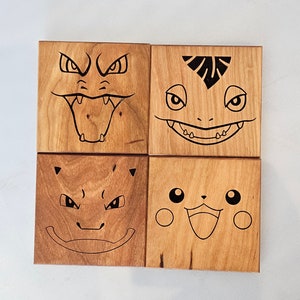 May include: Four wooden coasters with different Pokemon characters engraved on them. The characters are: Squirtle, Bulbasaur, Charmander, and Pikachu.