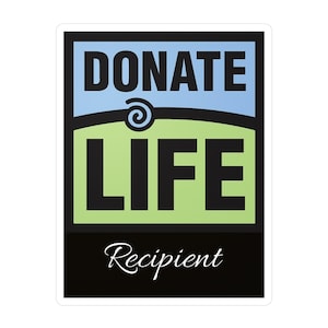 May include: Black and white sticker with the words "Donate Life" in a green and blue box. The words "Recipient" are written in cursive at the bottom of the sticker.