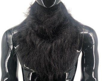 May include: A black faux fur collar. The collar is made of soft, fluffy fur and is perfect for adding a touch of warmth and style to any outfit.