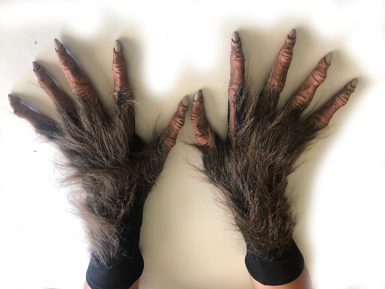 May include: A pair of brown werewolf hand gloves with black wrist cuffs. The gloves have long, hairy fingers and realistic-looking nails.