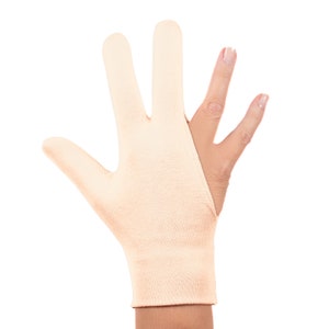 May include: A beige fingerless glove with a thumb hole. The glove is made of a soft, stretchy material and is designed to provide support and comfort to the hand.