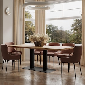 May include: A wooden dining table with a black metal base and six brown upholstered chairs. The table is set in a room with large windows and beige curtains.