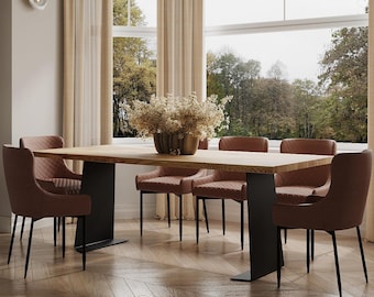 May include: A long wooden dining table with black metal legs, surrounded by six brown upholstered chairs. The table is set with a vase of dried flowers in the center.