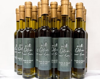 May include: A group of 18 small glass bottles of olive oil with gold caps and labels. The labels are green with white text and a simple floral design. The text on the labels reads "with olive our love" and "Guido & Sherri June 22, 2024".