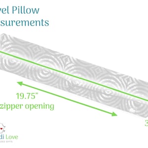 May include: A white travel pillow with a geometric pattern. The pillow is 34.25 inches long, 6.5 inches wide, and has a 19.75-inch zipper opening. The text "Travel Pillow Measurements" is at the top.