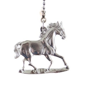 May include: Silver horse figurine hanging from a silver chain. The horse is in a running pose with its head turned to the side.