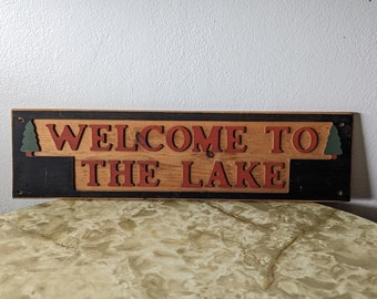 Vintage rustic wood Welcome To The Lake sign 26"x7" perfect for cabin dark blue with red lettering and green pine trees on either side