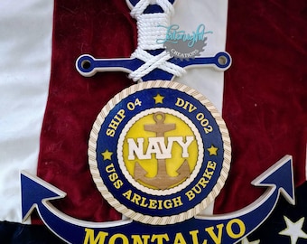 May include: Wooden navy-themed wall decor featuring a blue anchor with white rope detailing. The design includes a circular emblem with "NAVY" and "USS Arleigh Burke" text, plus the name "MONTALVO" in yellow.