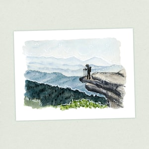 May include: A watercolor painting of a hiker standing on a cliff overlooking a mountain range. The sky is a light blue with white clouds, and the mountains are a hazy blue in the distance. The hiker is wearing a dark jacket and hat, and is holding a walking stick.