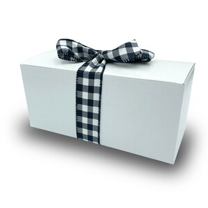 May include: A white gift box with a black and white checkered ribbon tied in a bow.