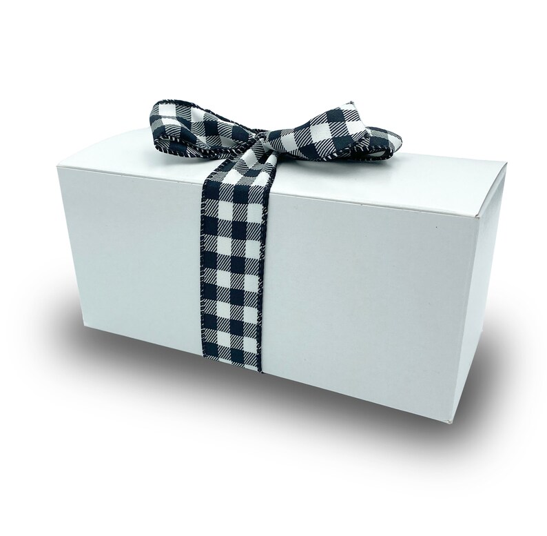 May include: A white gift box with a black and white checkered ribbon tied in a bow.