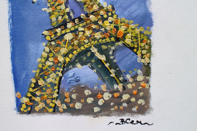 May include: A painting of the Eiffel Tower in Paris, France. The tower is painted in shades of yellow, orange, and green, with a blue background. The painting is signed "BCEM" in the bottom right corner.