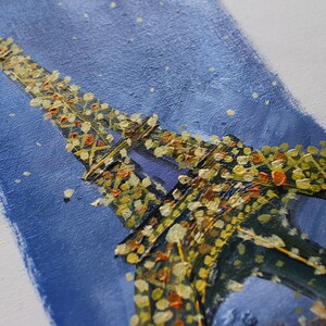 May include: A painting of the Eiffel Tower in Paris, France. The tower is painted in a dark blue and gold color scheme, with a blue sky background. The painting is done in a textured style, with visible brushstrokes.