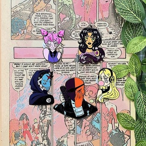 May include: Five enamel pins featuring comic book characters arranged on a vintage comic book page. The pins depict a pink-haired character, a dark-haired character, a hooded figure with a skull mask, a masked mercenary, and a blonde character.