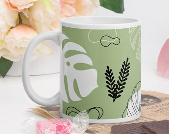 Mug monstera leaves abstract shapes on green background, coffee tea chocolate cup tropical leaves, plants, leaves, tropical, nature