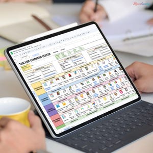May include: A digital tablet displaying a detailed spreadsheet titled "Teacher Command Center." The screen shows a colorful, organized layout with various sections and icons. A stylus rests on the screen, and a keyboard is attached. A yellow mug is in the foreground.