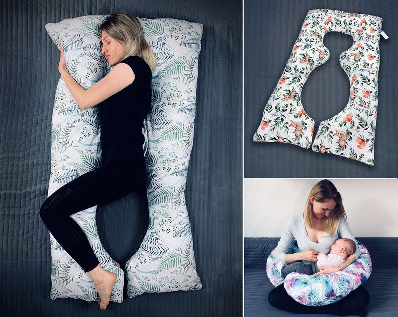 May include: A U-shaped body pillow featuring a white fabric cover with a green and blue fern leaf pattern. The pillow is shown in a full-length configuration for side sleeping and in a smaller, curved configuration for nursing support.