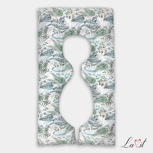 May include: A full-body U-shaped pillow featuring a white background with a repeating botanical pattern of green and dark teal fern leaves, thin blue swirling lines, and small dark berries. The pillow has a central cutout for body support.