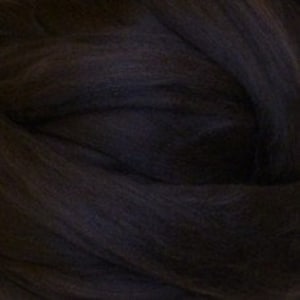 May include: A close-up of a dark gray wool roving, a type of fiber used for felting and spinning.