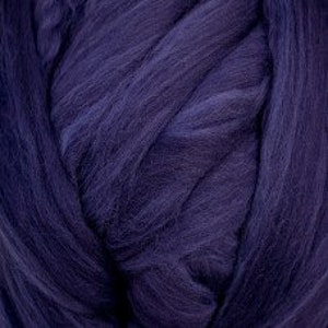 May include: A deep purple wool roving, a type of fiber used for spinning yarn or felting.