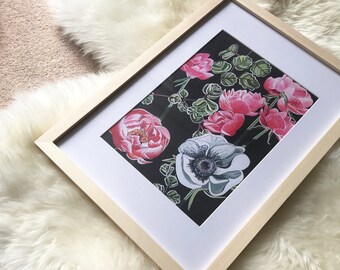 Op de afbeelding: Een ingelijste print van een bloemenontwerp met roze en witte bloemen op een zwarte achtergrond. De bloemen zijn in een cluster gerangschikt en hebben groene bladeren.