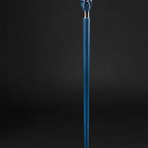 May include: A blue walking stick with a hand holding a wooden baseball bat with the word "Yankees" carved into it.