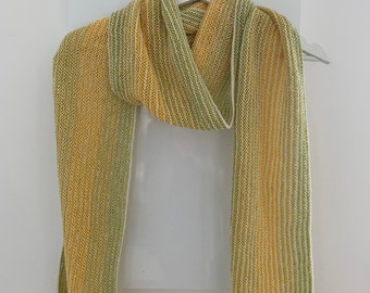 Hand knitted cotton scarf with a fading green and yellow  stripe with a golden glitter thread.