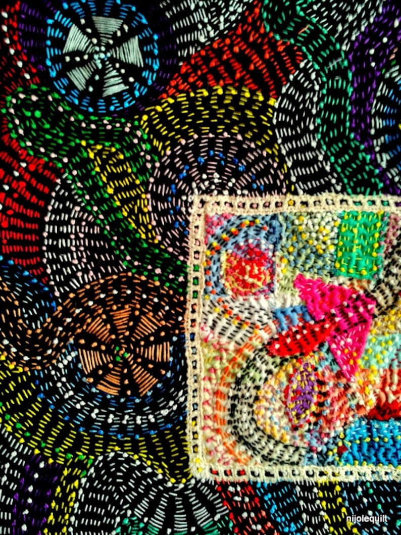 May include: A colorful patchwork quilt with a variety of geometric shapes and patterns. The quilt is made of different fabrics and colors, including red, green, blue, yellow, and white. The quilt is stitched together with a white thread. The quilt is a unique and beautiful piece of art.