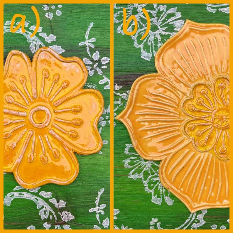 May include: Two close-up images of yellow flower-shaped ceramic pieces. The flowers have detailed petal designs and are set against a green background with white floral patterns. The ceramic pieces have a glossy finish.