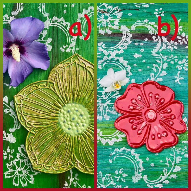 May include: Two ceramic flower-shaped dishes. One is green with a textured surface and a light green center. The other is red with a glossy finish. The dishes are on a green and teal background with white floral patterns.