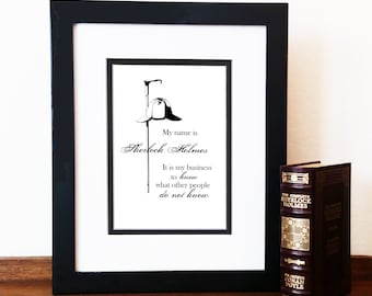 May include: A black framed print with a white background featuring a quote from Sherlock Holmes: "My name is Sherlock Holmes. It is my business to know what other people do not know."