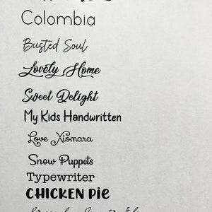 May include: A list of handwritten words in black ink on a white background. The words include "Chronic", "Colombia", "Busted Soul", "Lovely Home", "Sweet Delight", "My Kids Handwritten", "Love Xiomara", "Snow Puppets", "Typewriter", "CHICKEN Pie", and "Birmingham Signature Italic".