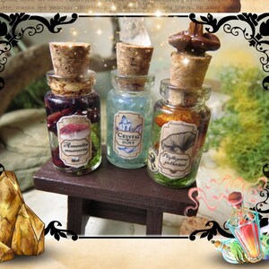 May include: Three small glass bottles with cork stoppers and labels. The bottles contain a variety of colorful liquids and dried ingredients. The labels read "Amanita Muscaria", "Crystal Dust", and "Fly Agaric Powder".