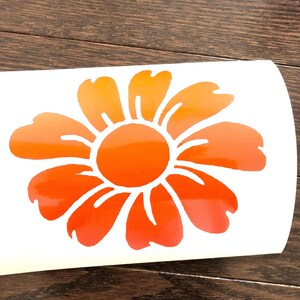 May include: An orange and yellow flower sticker with a gradient effect. The flower features a circular centre and multiple petals, suitable for decorating various surfaces.