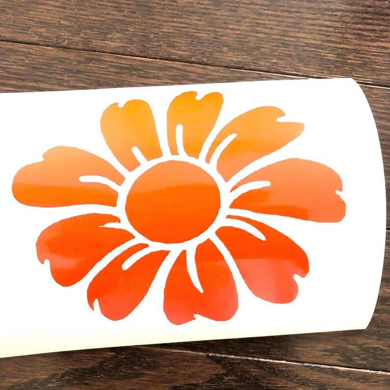 May include: An orange and yellow flower sticker with a gradient effect. The flower features a circular centre and multiple petals, suitable for decorating various surfaces.