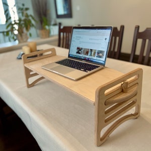 Large Adjustable lap desk being used as a stand up desk on a dining room table.  The desk is supporting a laptop and the height shows how one could stand during conference calls. Great gift idea for work from home friends or family