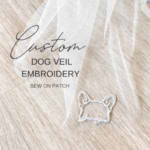 Peut inclure: Un voile blanc pour chien avec le texte "Custom DOG VEIL EMBROIDERY SEW ON PATCH". Un écusson brodé blanc d'une tête de chien avec le nom "Georgie" est cousu sur le voile. Le voile est en tissu léger et transparent.