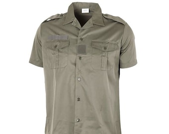 May include: An olive-green short-sleeved shirt with a button-down front. It features two buttoned chest pockets, shoulder epaulettes, and a small patch above one pocket. The shirt has a classic collar.