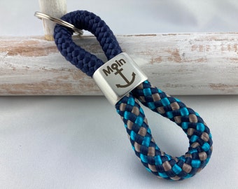 Key ring made of sailing rope with a silver-plated intermediate piece with engraving "Moin mit Anker", dark blue/dark blue-petrol-grey