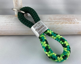 Key ring made of sailing rope with a silver-plated intermediate piece with engraving "Every day is a new adventure", dark green/green mix