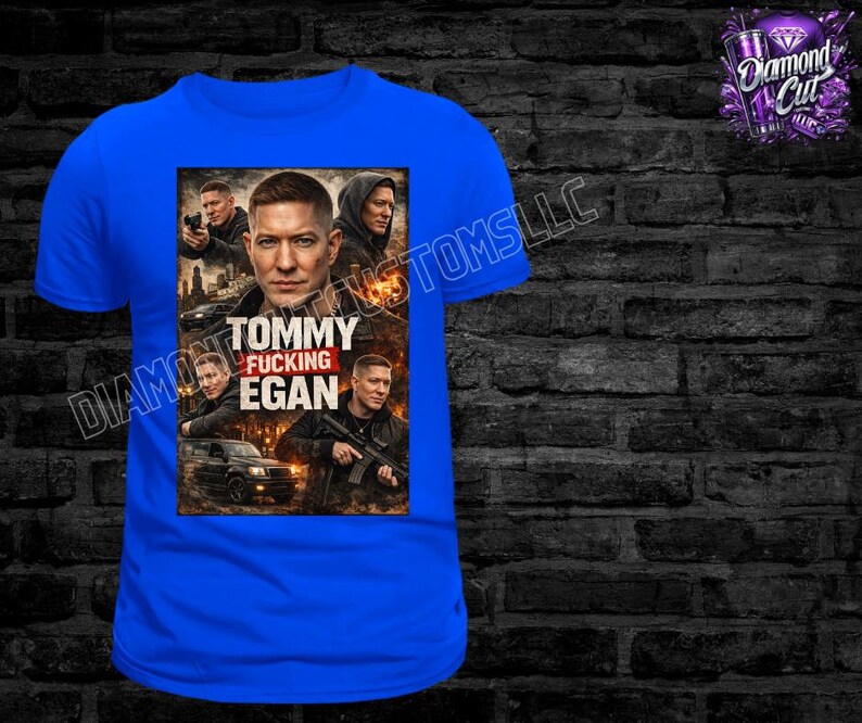 May include: A royal blue t-shirt featuring a graphic of a man with the text "TOMMY FUCKING EGAN". The graphic includes images of other men and a car. The shirt has a crew neck and short sleeves.