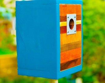 Birdhouse in glossy teal with a multi-wood front snd removable back