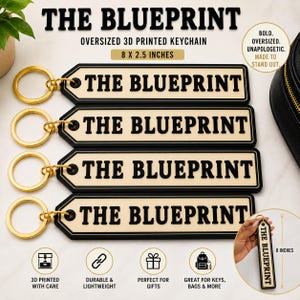 May include: Four rectangular 3D printed keychains with gold-toned metal rings. Each keychain is cream-colored with a black border and the text THE BLUEPRINT in bold black letters. The dimensions are clearly labeled as 8 by 2.5 inches.