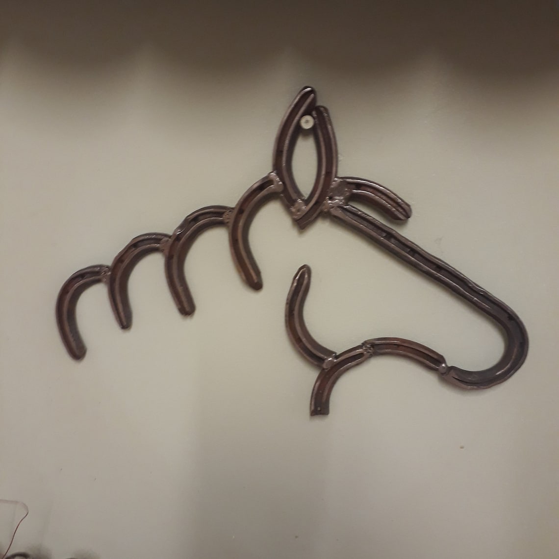 Horse Shoe Wall Art. A Sculpture of a Horses Head Made From Several