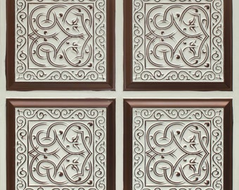 May include: Four square tiles with a white background and a brown border. Each tile features a raised, intricate, white floral design.
