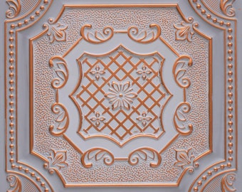 May include: A white ceiling tile with a decorative, embossed design in a copper colour. The design features a central flower with a grid pattern and intricate scrollwork around the edges.
