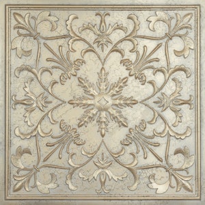 May include: A decorative tile with a distressed white background and a raised gold design. The design features a central snowflake surrounded by intricate floral patterns.
